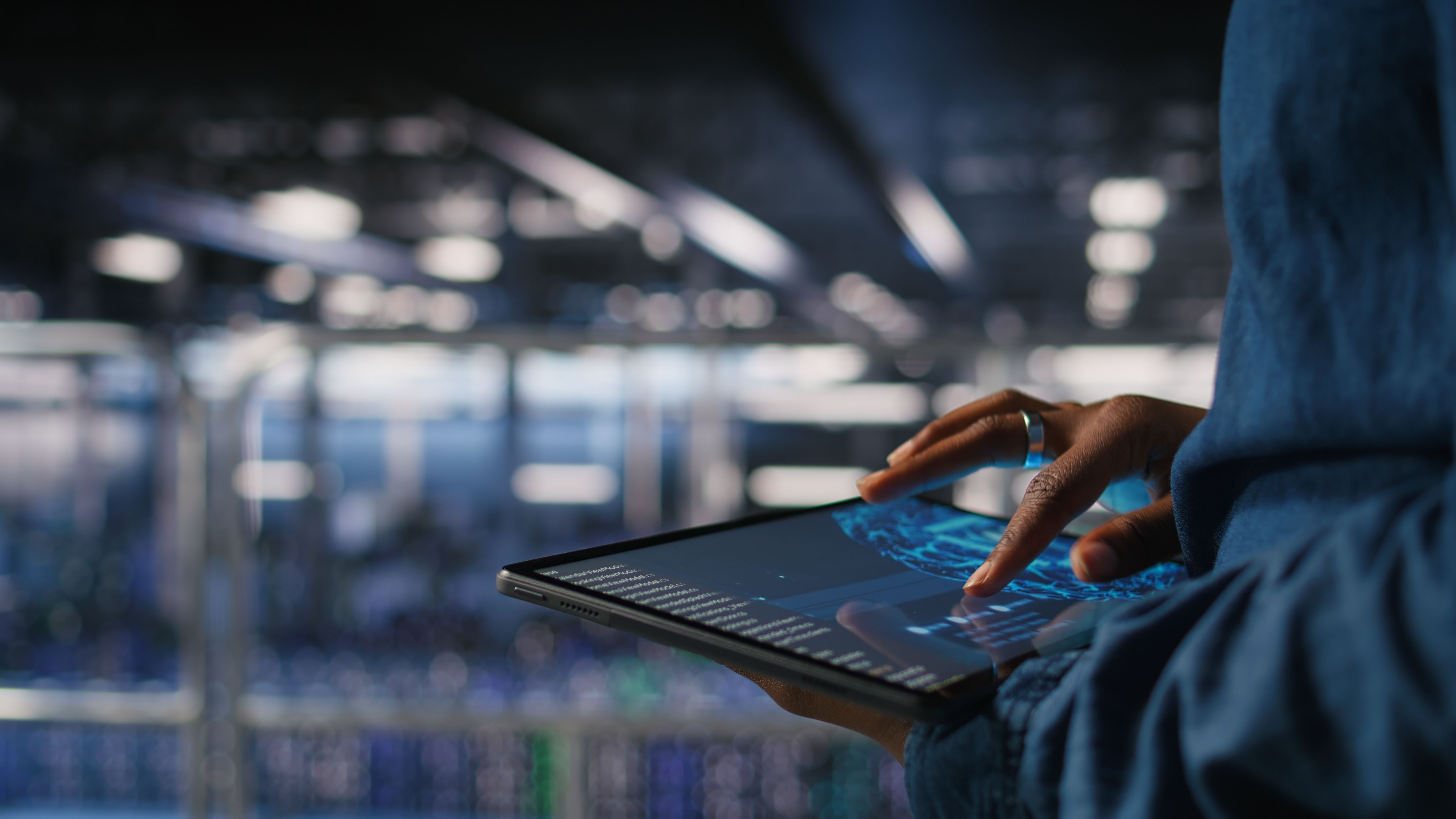 An engineer working through system data on a tablet