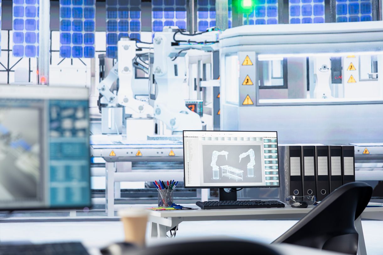 Engineer monitoring electronics production on screen