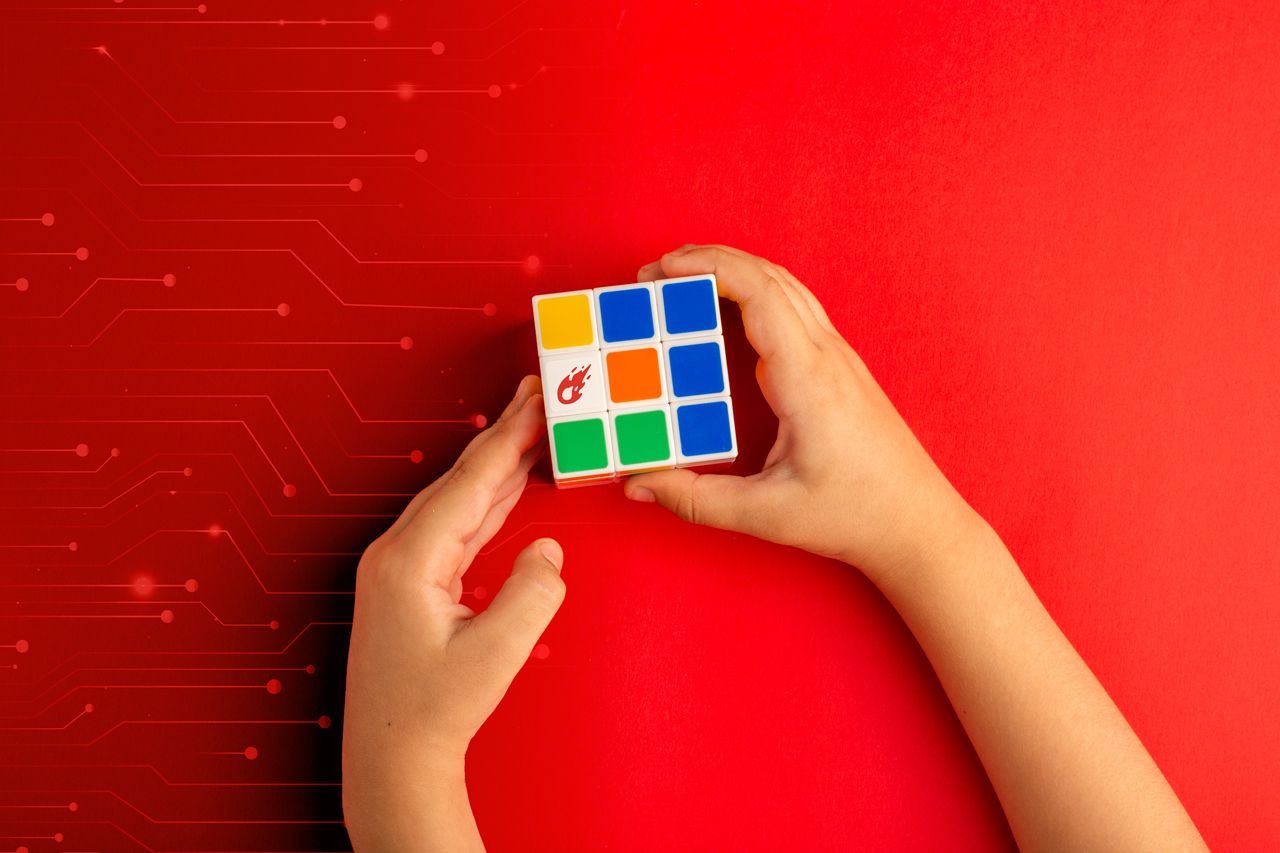 Hands solving a cube, framed by circuit lines